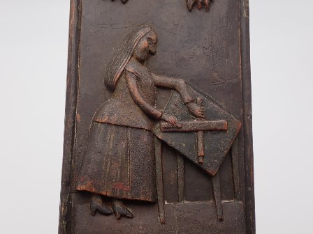 Depiction of a woman using a mangle board, carved on a Norwegian mangle board, dated 1793